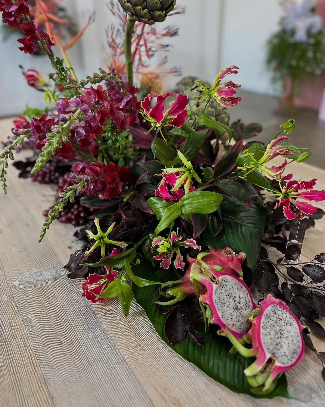Dragon fruit, Grapes and Artichokes - a feature along with dark hues of the Copper beech and snapdragons. Beautiful Gloriosa Lily a highlight